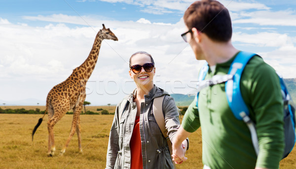 Stock photo: smiling couple with backpacks traveling in africa