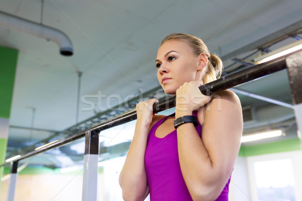 woman exercising and doing pull-ups in gym Stock photo © dolgachov