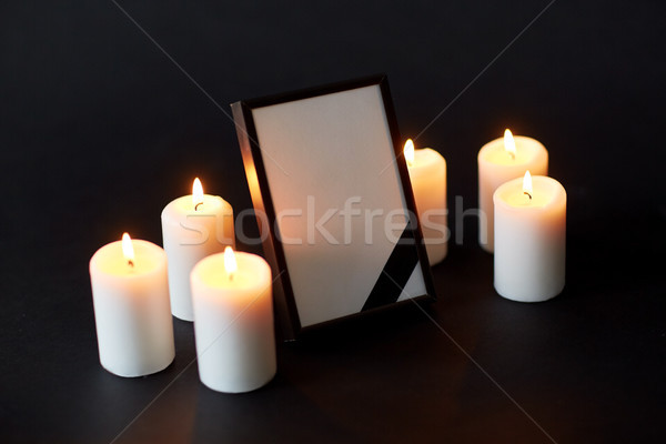 black ribbon on photo frame and candles at funeral Stock photo © dolgachov