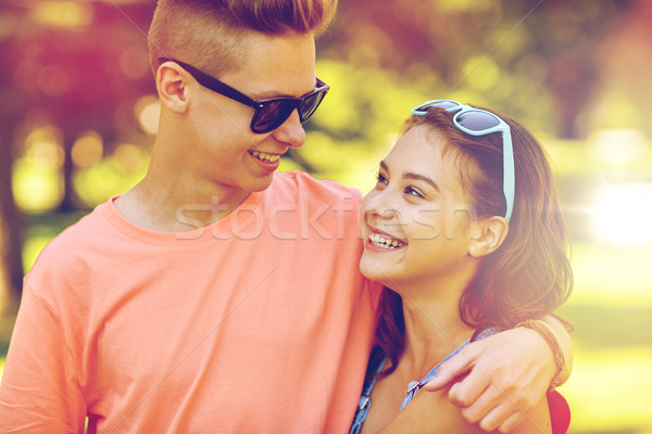 happy teenage couple looking at each other in park Stock photo © dolgachov