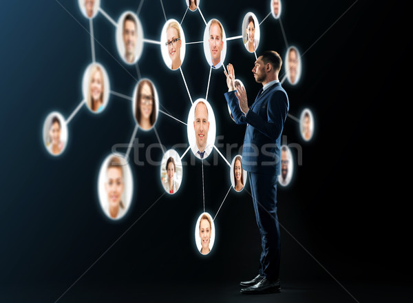 buisnessman looking at contacts network Stock photo © dolgachov
