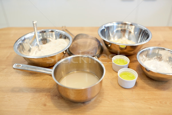 bowls with flour and egg whites at bakery kitchen Stock photo © dolgachov