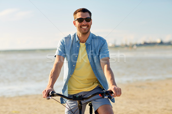 Stock photo: happy man riding bicycle along summer beach