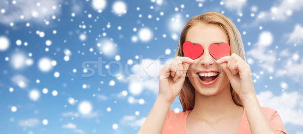 Stock photo: happy young woman with red heart shapes on eyes