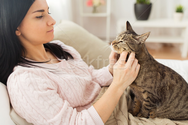 close up of woman with tabby cat in bed at home Stock photo © dolgachov