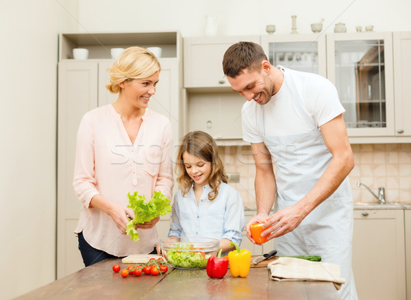 happy family making dinner in kitchen Stock photo © dolgachov