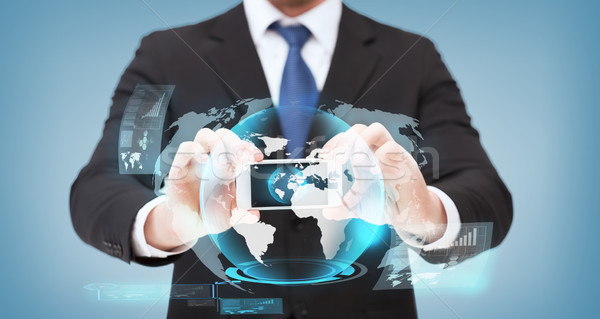 Biznesmen smartphone świecie hologram działalności Zdjęcia stock © dolgachov
