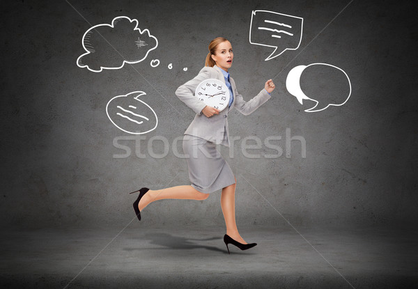 stressed young businesswoman with clock running Stock photo © dolgachov