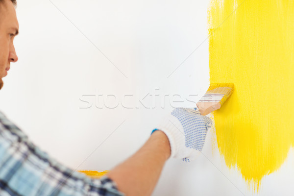 Stock photo: close up of male in gloves holding paintbrush