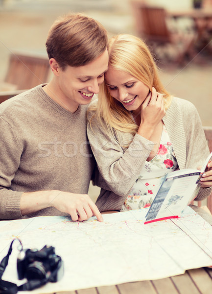 Stock photo: couple with map, camera and travellers guide