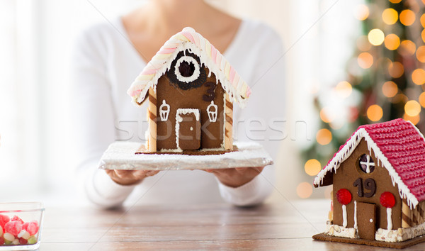 close up of woman showing gingerbread house Stock photo © dolgachov