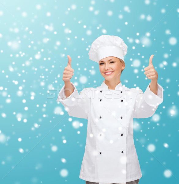 smiling female chef showing thumps up Stock photo © dolgachov