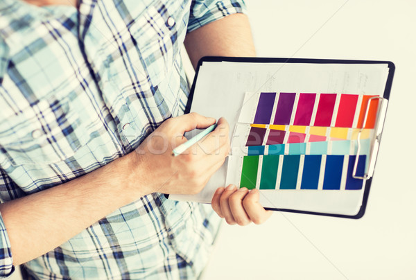 man with color samples for selection Stock photo © dolgachov