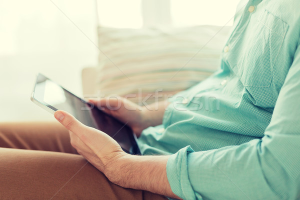 close up of man with tablet pc computer at home Stock photo © dolgachov