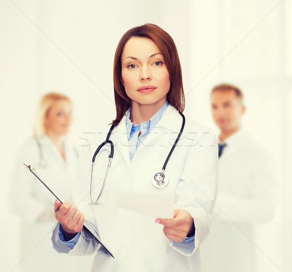 calm female doctor with clipboard Stock photo © dolgachov