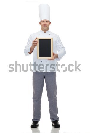 happy male chef cook holding blank menu board Stock photo © dolgachov