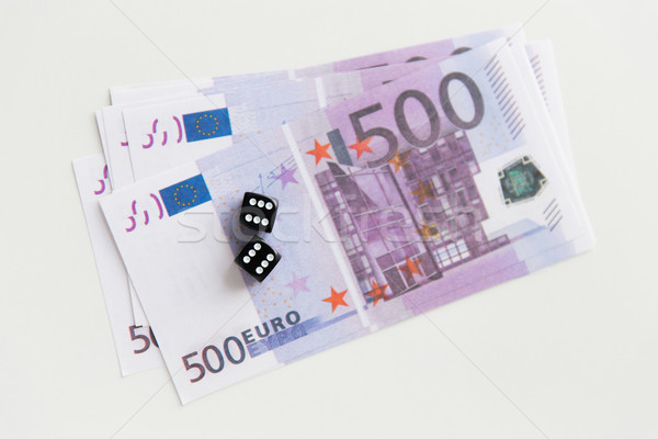close up of black dice and euro cash money Stock photo © dolgachov