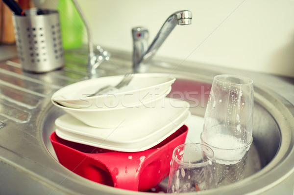 close up of dirty dishes washing in kitchen sink Stock photo © dolgachov