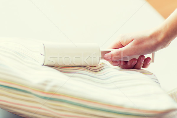 close up of woman hand with sticky roller cleaning Stock photo © dolgachov