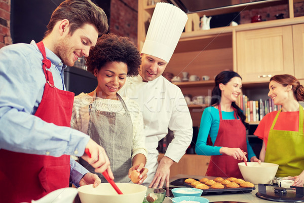 happy friends and chef cook baking in kitchen Stock photo © dolgachov