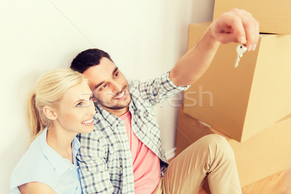 couple with key and boxes moving to new home Stock photo © dolgachov