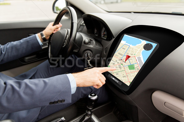 close up of man driving car with gps navigator map Stock photo © dolgachov