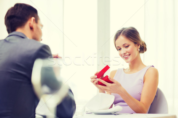 Excité jeune femme regarder copain boîte restaurant [[stock_photo]] © dolgachov