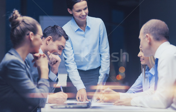 smiling female boss talking to business team Stock photo © dolgachov