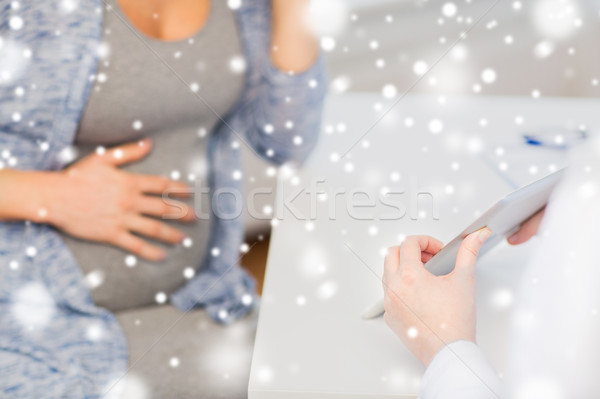 close up of doctor with tablet and pregnant woman Stock photo © dolgachov