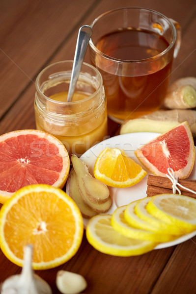 ginger tea with honey, citrus and garlic on wood Stock photo © dolgachov