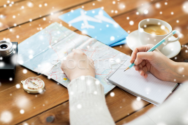 hands with map and coffee writing to notebook Stock photo © dolgachov