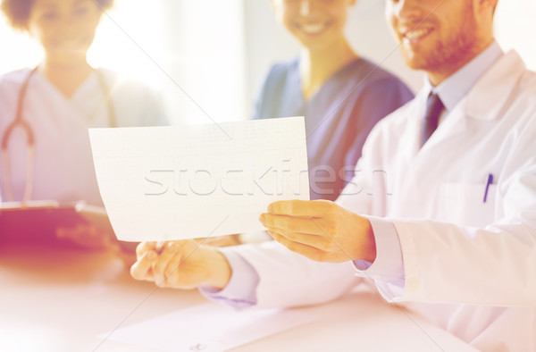 close up of doctors with cardiogram at hospital  Stock photo © dolgachov