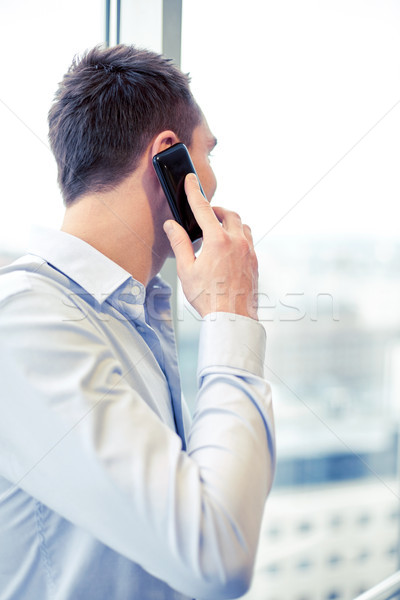 businessman calling on smartphone in office Stock photo © dolgachov