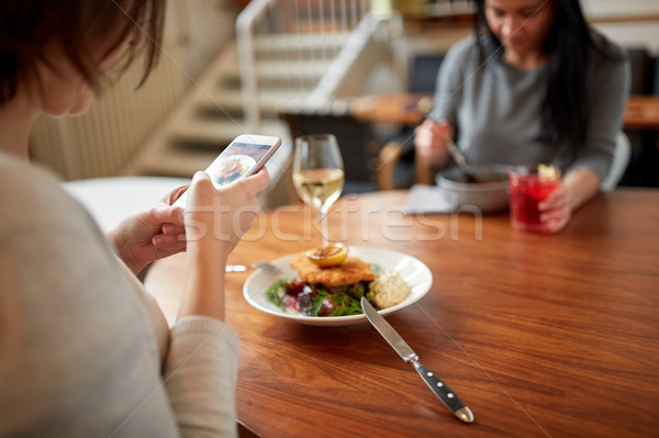 Stock photo: women with smartphones and food at restaurant