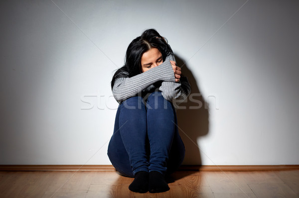 unhappy woman crying on floor at home Stock photo © dolgachov