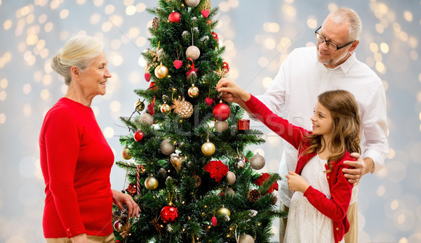 grandparents and granddaughter at christmas tree Stock photo © dolgachov