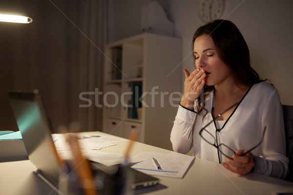 Fáradt nő papírok ásít éjszaka iroda Stock fotó © dolgachov