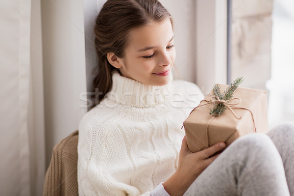 girl with christmas gift sitting at home Stock photo © dolgachov