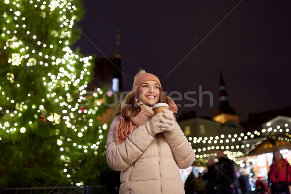 happy young woman with coffee at christmas market Stock photo © dolgachov