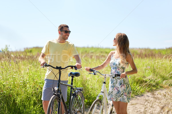 happy couple with bicycles on country road Stock photo © dolgachov