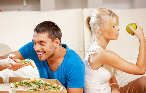 couple eating different food Stock photo © dolgachov
