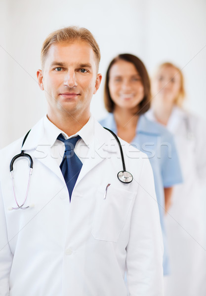 doctor with stethoscope and colleagues Stock photo © dolgachov