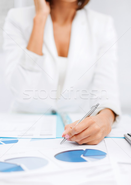 Stock photo: woman with documents taking phone call