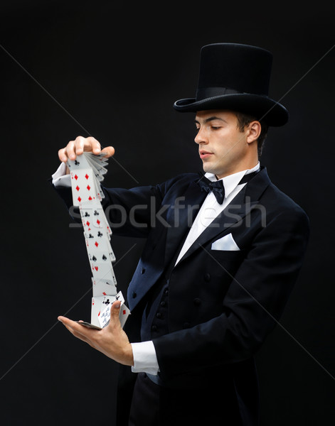 magician showing trick with playing cards Stock photo © dolgachov