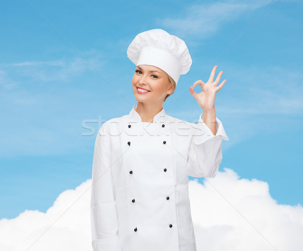 smiling female chef showing ok hand sign Stock photo © dolgachov