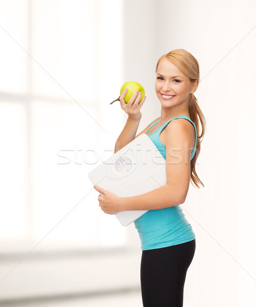 sporty woman with scale and green apple Stock photo © dolgachov