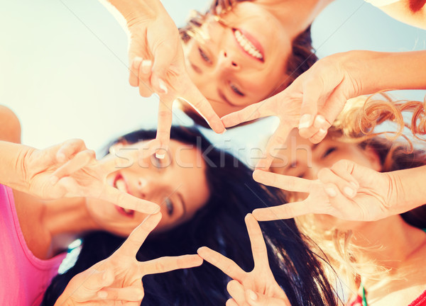 Lányok lefelé néz mutat ujj öt kézmozdulat Stock fotó © dolgachov