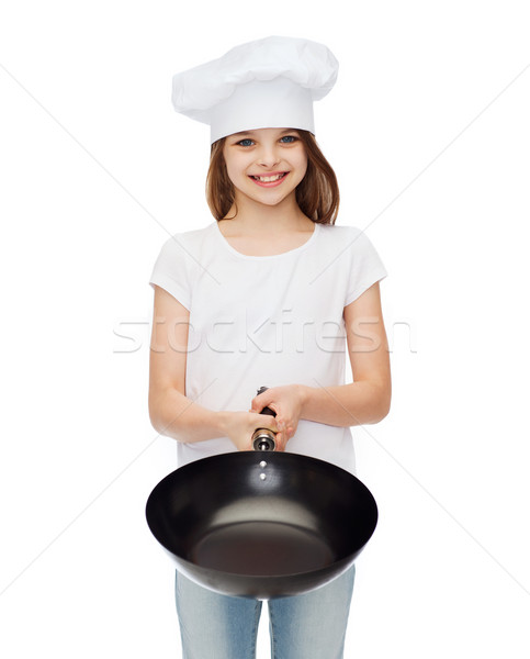 smiling girl in cook hat giving frying pan Stock photo © dolgachov