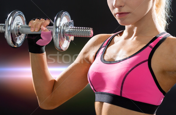 close up of sporty woman with heavy steel dumbbell Stock photo © dolgachov