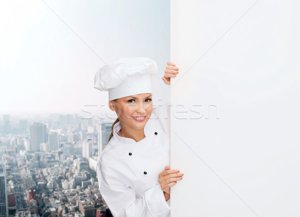 Stock photo: smiling female chef with white blank board